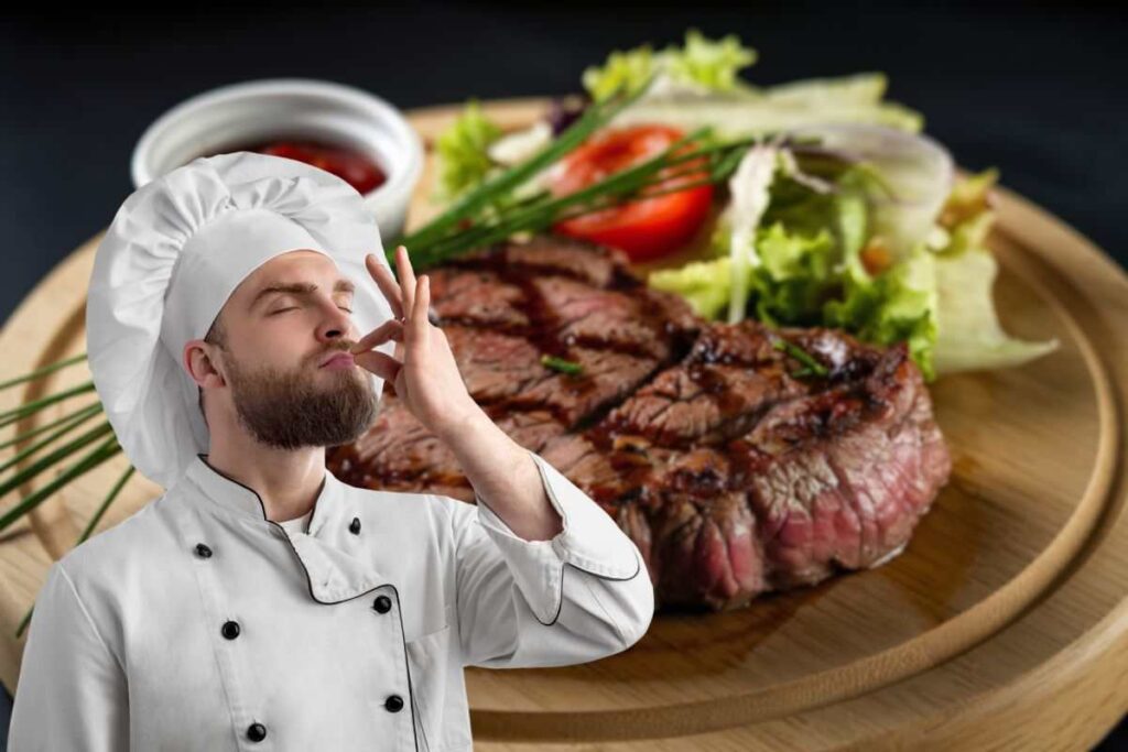 carne alla griglia nel piatto in insalata e chef che manda bacio