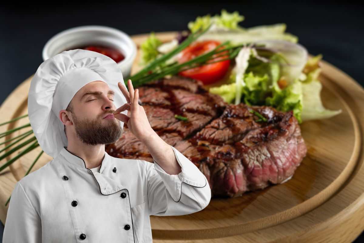carne alla griglia nel piatto in insalata e chef che manda bacio