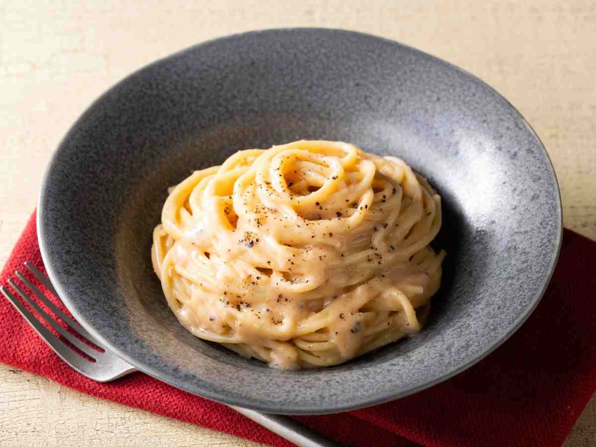 spaghetti cremosi in un piatto nero